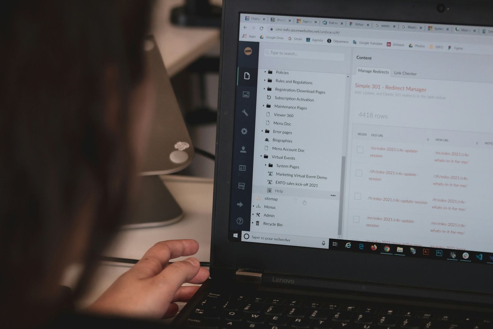 A person working through messages on a laptop at a desk